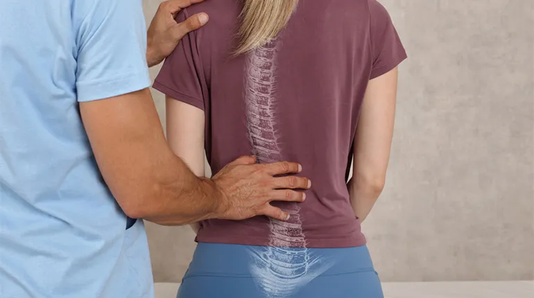 The doctor examines the back and spine of a patient.